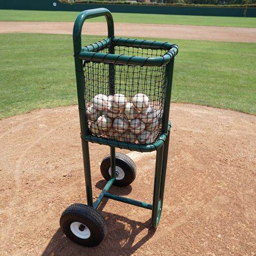 A green replacement wheel for a batting practice ball cart, displayed on a dirt surface with baseballs loaded on the cart.